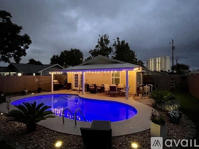A backyard with a pool and a gazebo.