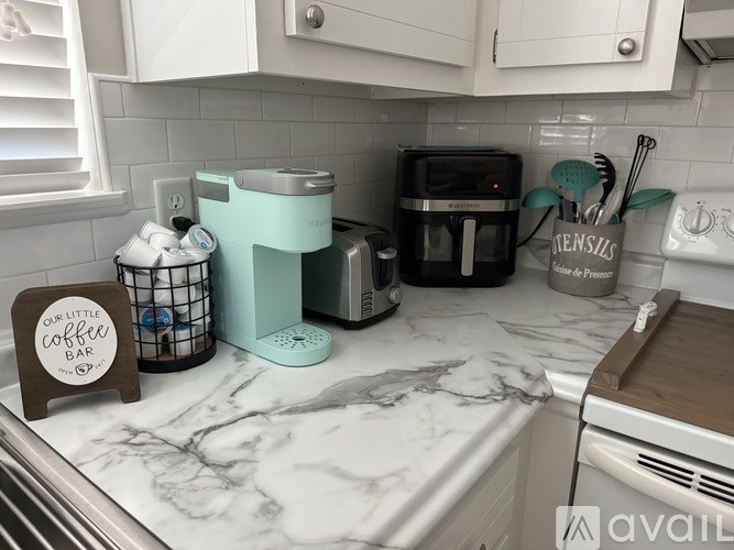 A decorative tray with a sign that says "oh so thankful" and a football theme is on a grey couch.