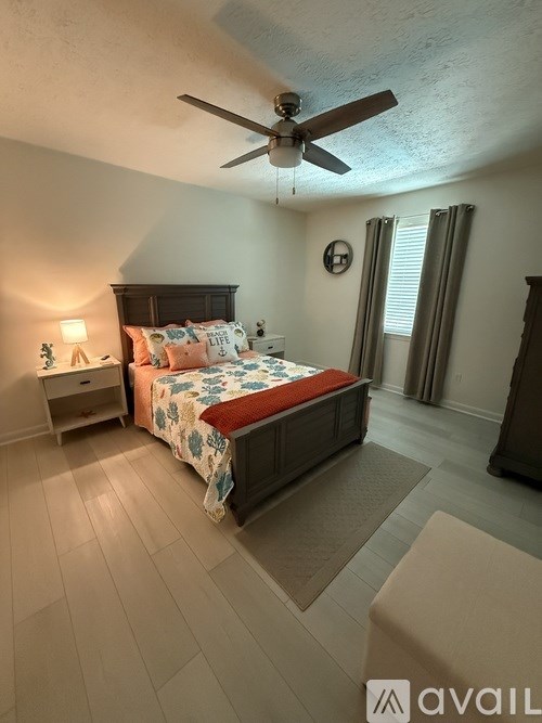 A bedroom with a large bed and a mirror on the wall.