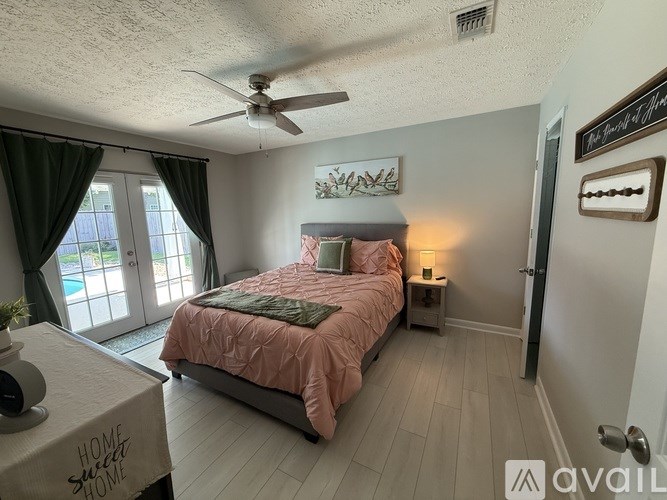 A bathroom with a sink, mirror, and toilet.