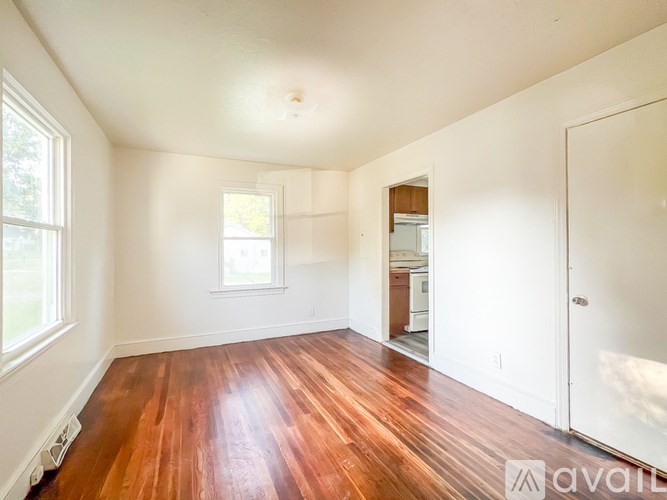 A room with wooden floors and white walls.