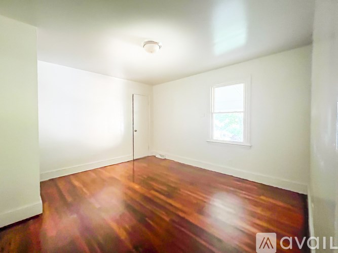 A room with wooden floors and a window.