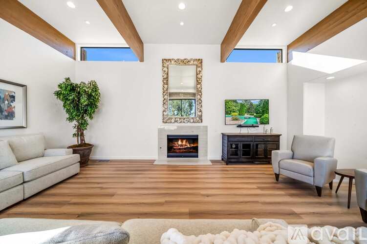 A living room with a fireplace and a painting on the wall.