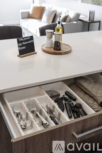 A kitchen drawer with utensils and a sign that says "Welcome to the kitchen".