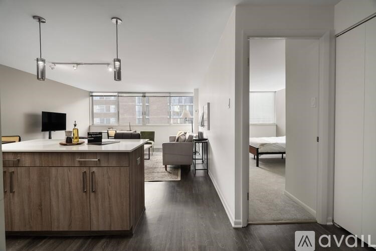 A modern kitchen with wooden cabinets and a television.