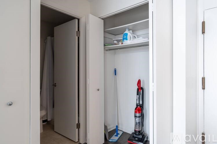 A vacuum cleaner is on the floor next to a door.