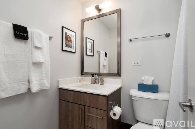 A bathroom with a white sink and a white towel hanging on the wall.