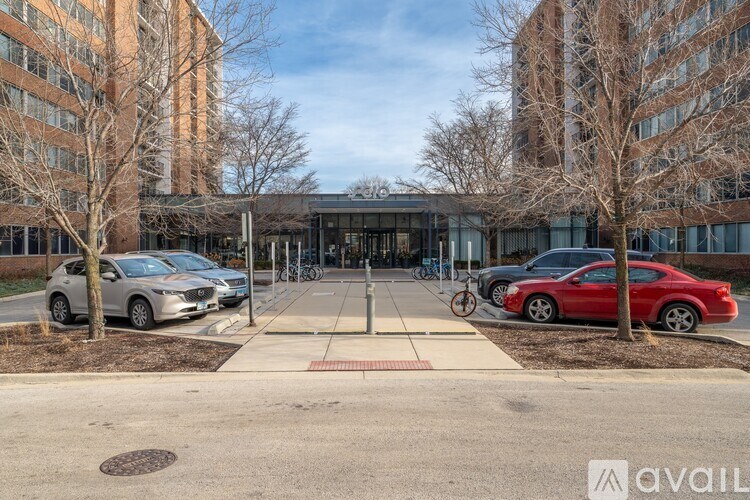 A parking lot with cars and a building in the background.