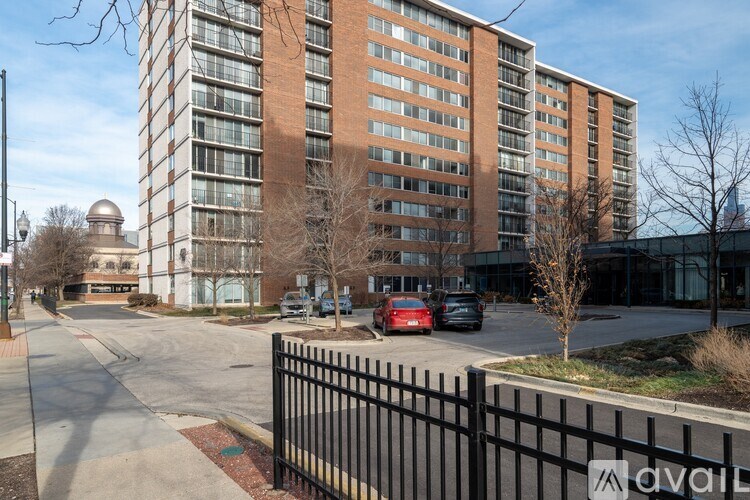 A tall building with a black fence in front of it.