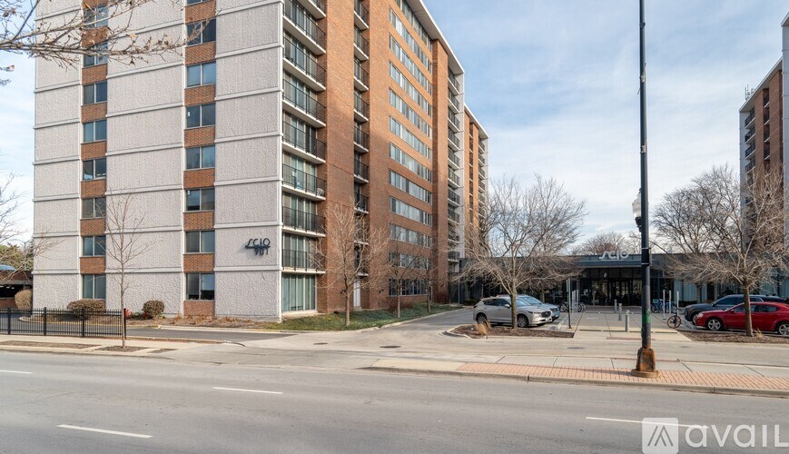 A tall building with a sign that reads "440" is in the background of a street scene.