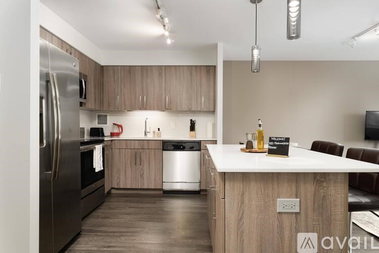 A kitchen with a refrigerator, stove, and dishwasher.