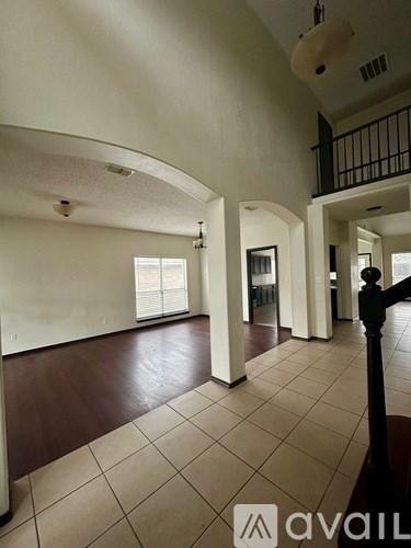 A large open space with a black railing on the right side.