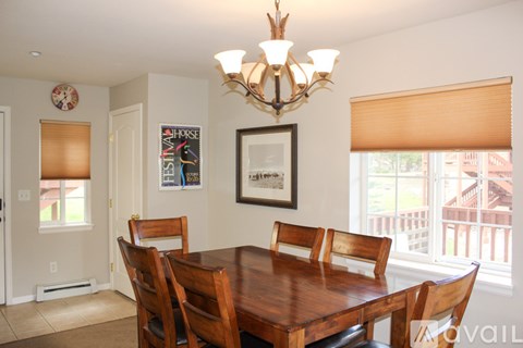 A kitchen with granite countertops and a white refrigerator.