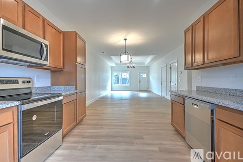 A kitchen with wooden cabinets and a stainless steel oven.