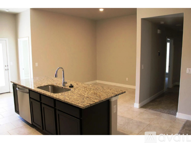 A kitchen with a granite countertop and a sink.