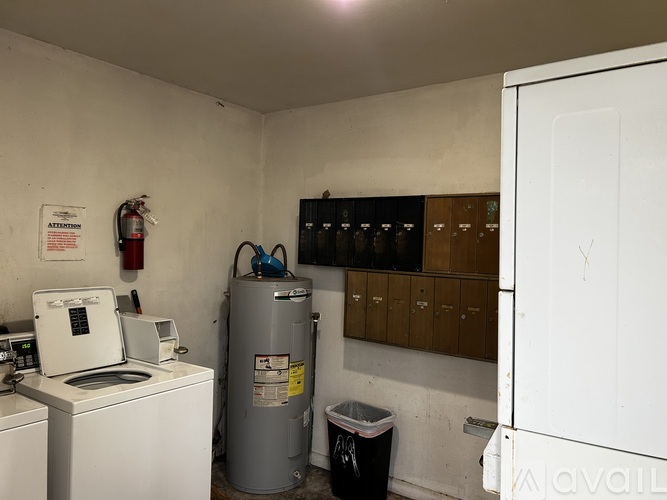 A laundry room with a washing machine, dryer, and a water heater.