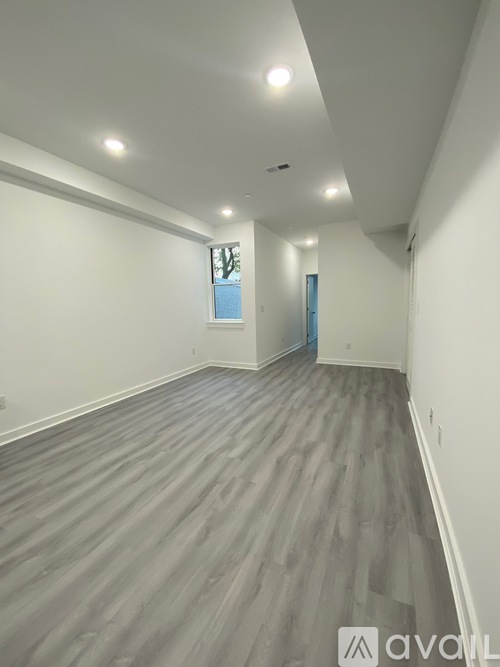 A room with grey flooring and white walls.
