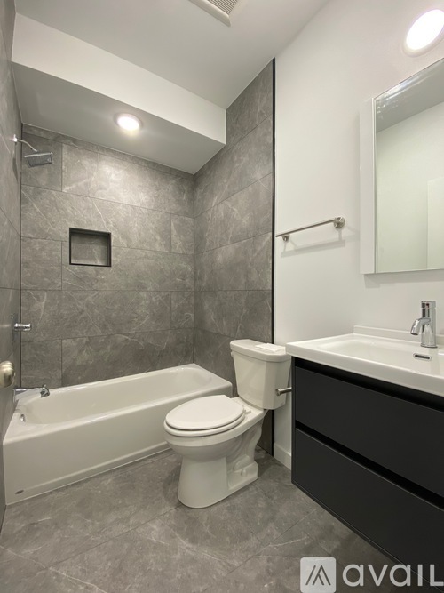 A bathroom with a white toilet and a white bathtub.