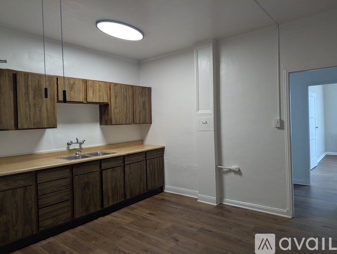 A kitchen with wooden cabinets and a sink.