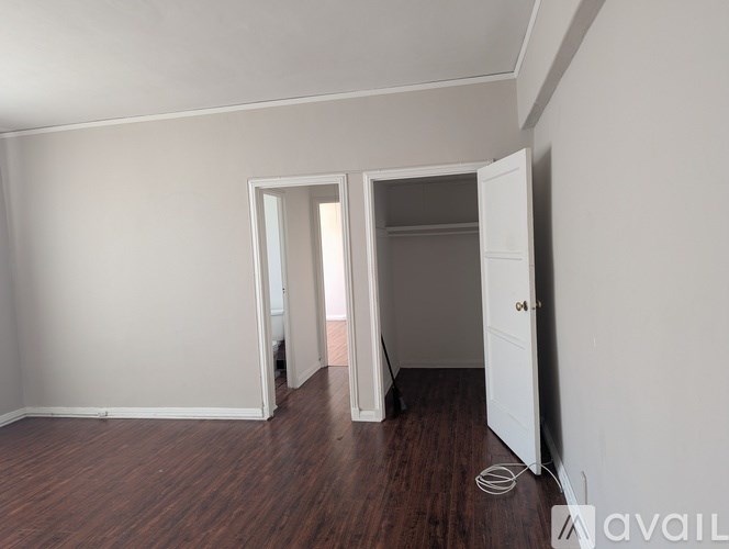 A room with a white door and a white wall.