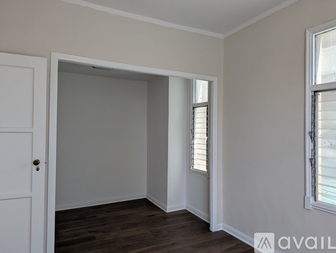 A room with a white door and a window with blinds.