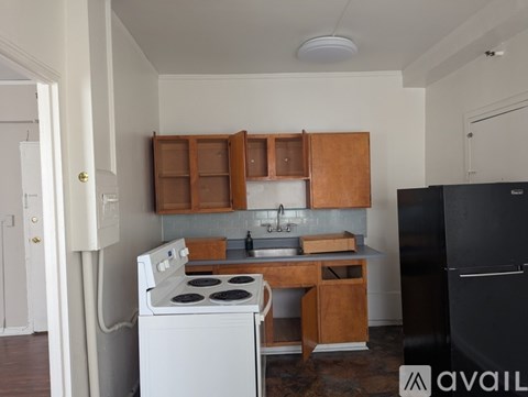 A kitchen with a white stove and black refrigerator.