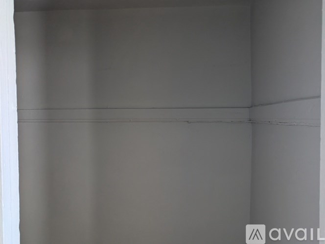 A view of the Hollywood sign with palm trees in the foreground.