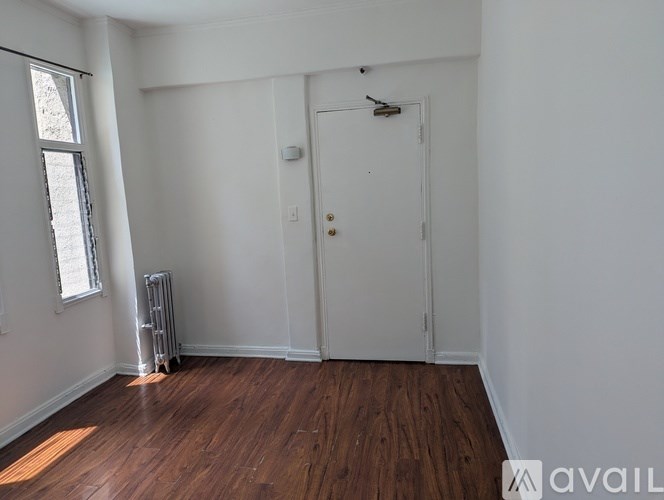 A room with a white door and a window with a white frame.