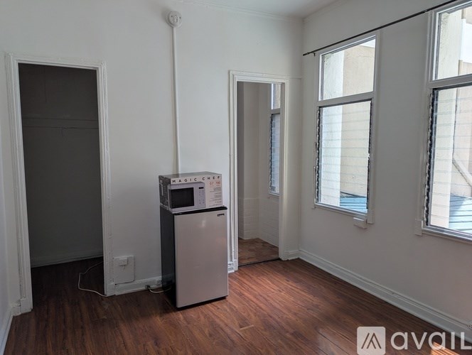 A room with a Magic Coffee machine on a wooden floor.