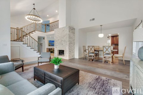 A living room with a grey sofa and a wooden coffee table.