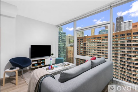 A living room with a grey couch and a blue chair.