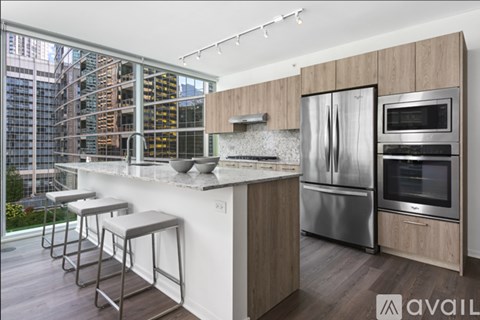 A modern kitchen with a view of a building under construction.