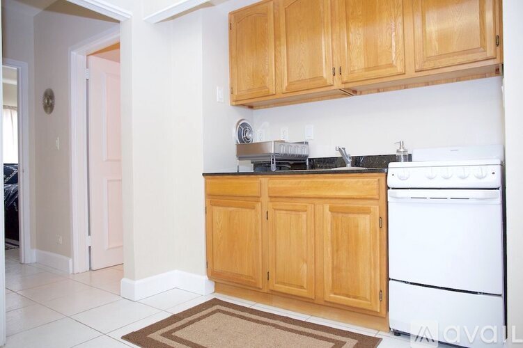A kitchen with wooden cabinets and white appliances.