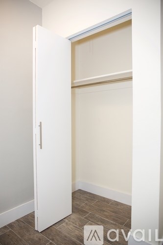 A white door is open to a small room.