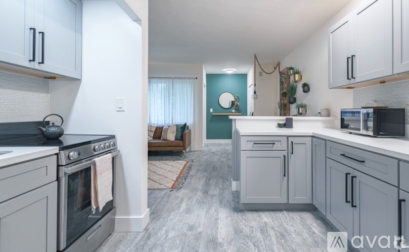A kitchen with a stove, oven, and cabinets.