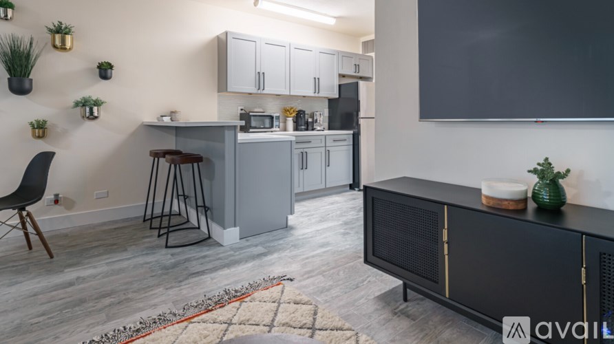 A kitchen with a black countertop and a grey cabinet.