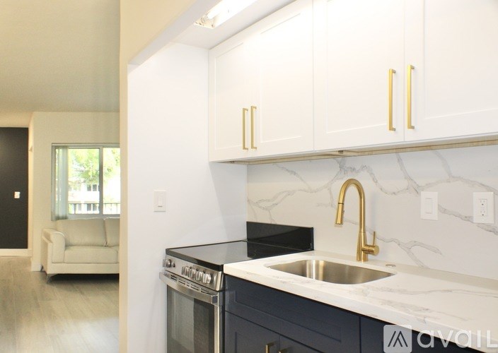 A kitchen with a black oven and white cabinets.