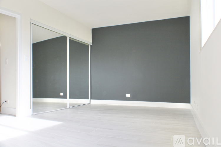 A room with a grey wall and a white floor.