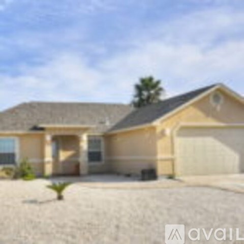 A house with a brown roof and beige walls is available for sale.