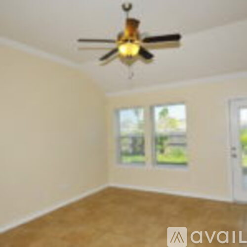 A room with a ceiling fan and two windows.