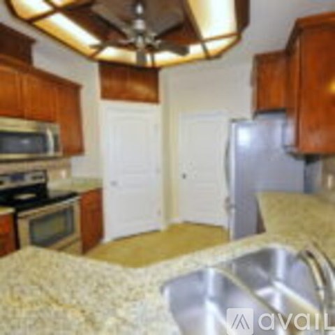 A kitchen with wooden cabinets and a stove top oven.