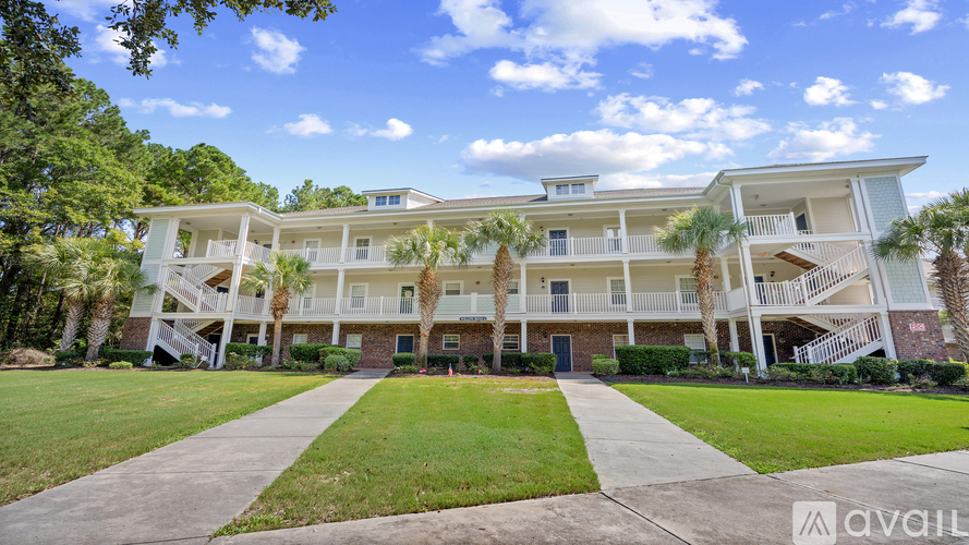 A large apartment complex with a walkway in front.