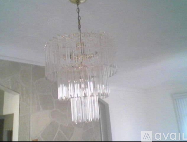 A chandelier with many glass prisms hanging from the ceiling.