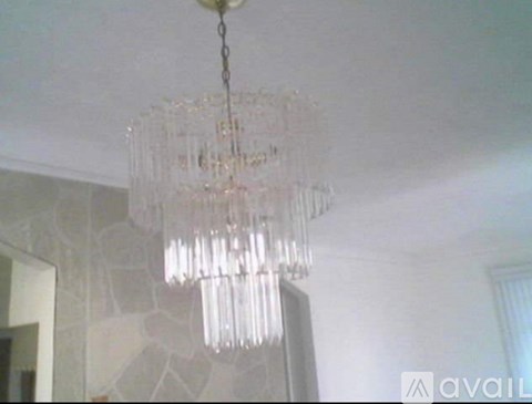 A chandelier with many glass prisms hanging from the ceiling.