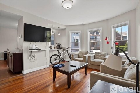A living room with a television, a bicycle, and a coffee table.