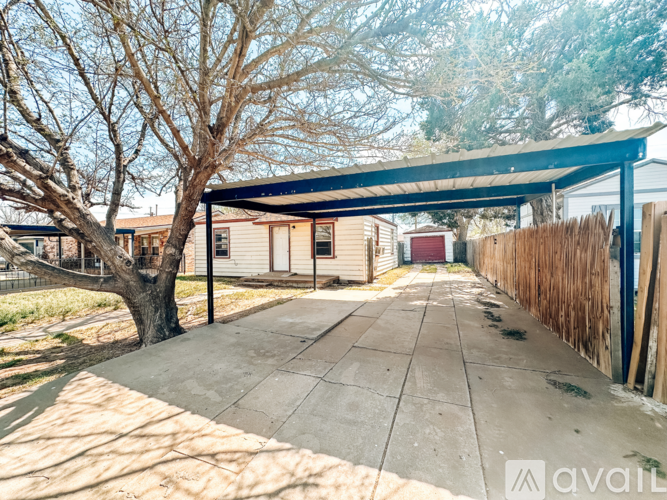 A covered walkway leads to a row of mobile homes.