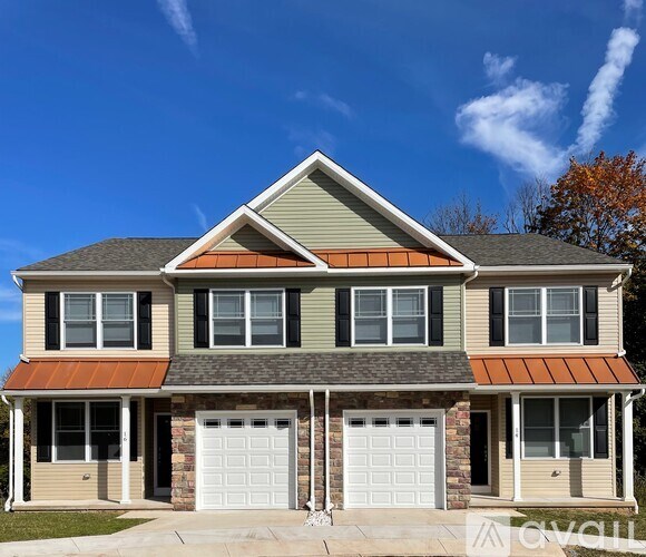 A two-story house with a garage on the lower level.