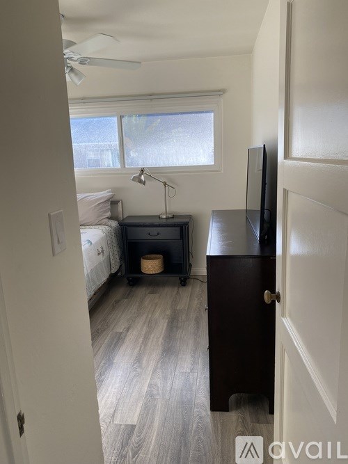 A white bathroom with a tub, sink, and mirror.
