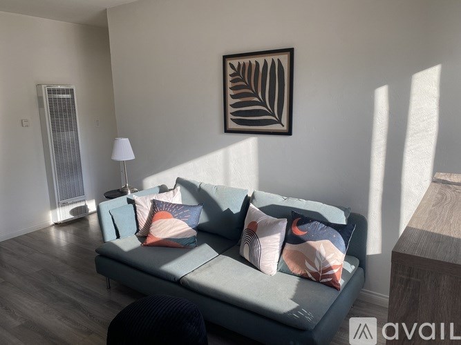 A room with a ceiling fan and a window with blinds.
