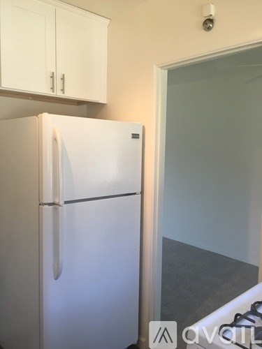 A white refrigerator in a kitchen with a glass door.